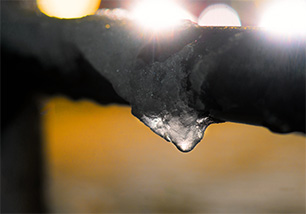 close up of frozen pipe in basement